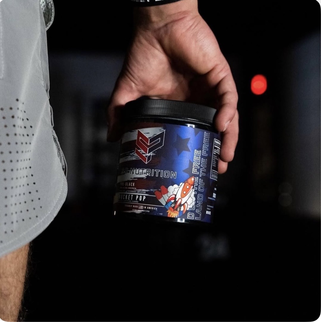 SP Nutrition Rocket Pop supplement held in a gym setting